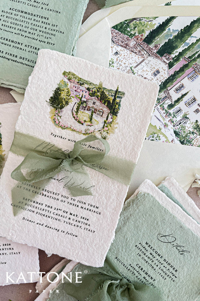 Close up of handmade cotton paper invitation highlighting textured deckled edges, soft watercolor venue illustration and elegant typography.