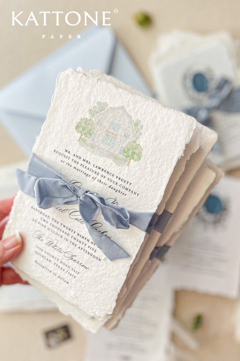 Celebrate your special day with our exquisite Wedding Invitations, featuring a stunning watercolor venue illustration. Each invite is crafted from premium handmade paper with a beautiful deckled edge, adding a touch of elegance to your wedding. Perfect for couples who appreciate artistry and personalization. Contact for a quote tailored to your needs. Make your invitations as unforgettable as your love story with our unique designs.&nbsp;