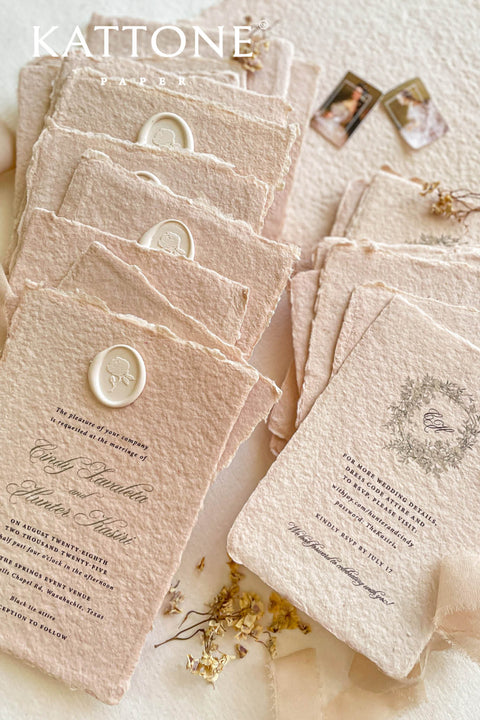 Elevate your wedding with our exquisite Handmade Paper Wedding Invitations featuring beautiful deckled edges. Crafted with love and attention to detail, these elegant invitations are tied together with luxurious silk ribbon, adding a touch of sophistication to your special day. Each piece is uniquely handmade, ensuring your announcements are as one-of-a-kind as your love story. 