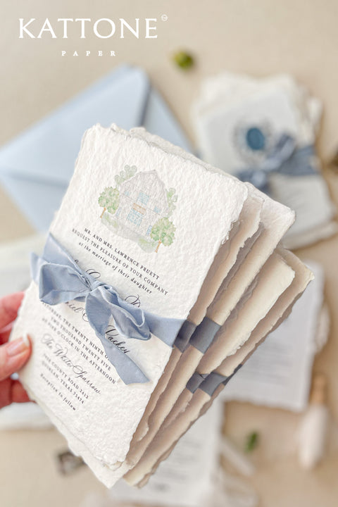Celebrate your special day with our exquisite Wedding Invitations, featuring a stunning watercolor venue illustration. Each invite is crafted from premium handmade paper with a beautiful deckled edge, adding a touch of elegance to your wedding. Perfect for couples who appreciate artistry and personalization. Contact for a quote tailored to your needs. Make your invitations as unforgettable as your love story with our unique designs.&nbsp;