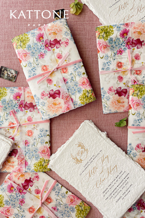 Announce your special day with a touch of modern romance with these exquisite wedding invitations. Perfect for a summer wedding, each suite features a delicate floral design printed on a translucent vellum jacket. Your personal custom monogram adds an elegant and personal touch, and the invitations are printed on luxurious handmade paper, creating a beautifully layered and bespoke stationery set.