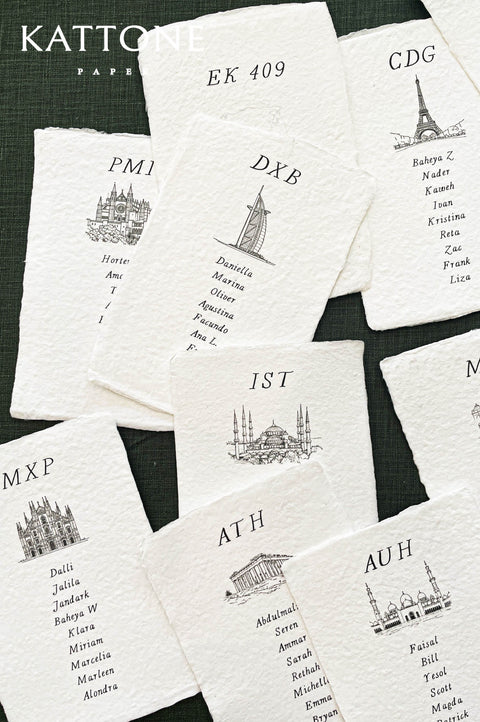 Fine line architectural drawings of landmarks including cathedral, mosque and Eiffel Tower printed on place cards.