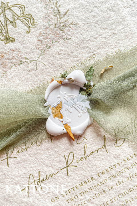 Soft, organic, and undeniably romantic - this colored handmade paper wedding invitation suite beautifully captures the essence of nature-inspired elegance. Printed on luxury blush-toned deckled-edge cotton paper, each piece is a work of art, blending timeless craftsmanship with delicate botanical elements and refined greenery details. At its heart lies a custom hand-drawn monogram, surrounded by soft watercolor foliage - a symbol of the couple’s unity and natural grace. 