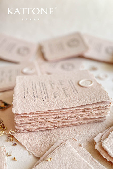 Elevate your wedding with our exquisite Handmade Paper Wedding Invitations featuring beautiful deckled edges. Crafted with love and attention to detail, these elegant invitations are tied together with luxurious silk ribbon, adding a touch of sophistication to your special day. Each piece is uniquely handmade, ensuring your announcements are as one-of-a-kind as your love story. 