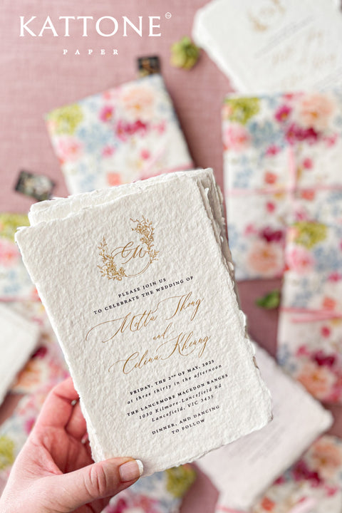 Announce your special day with a touch of modern romance with these exquisite wedding invitations. Perfect for a summer wedding, each suite features a delicate floral design printed on a translucent vellum jacket. Your personal custom monogram adds an elegant and personal touch, and the invitations are printed on luxurious handmade paper, creating a beautifully layered and bespoke stationery set.
