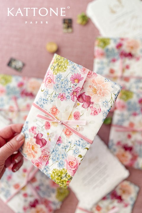 Announce your special day with a touch of modern romance with these exquisite wedding invitations. Perfect for a summer wedding, each suite features a delicate floral design printed on a translucent vellum jacket. Your personal custom monogram adds an elegant and personal touch, and the invitations are printed on luxurious handmade paper, creating a beautifully layered and bespoke stationery set.