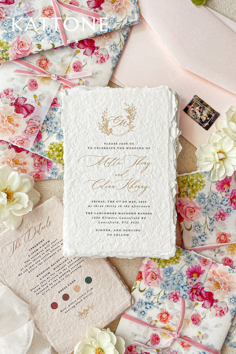 Announce your special day with a touch of modern romance with these exquisite wedding invitations. Perfect for a summer wedding, each suite features a delicate floral design printed on a translucent vellum jacket. Your personal custom monogram adds an elegant and personal touch, and the invitations are printed on luxurious handmade paper, creating a beautifully layered and bespoke stationery set.