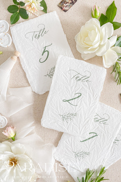 These embossed handmade paper table numbers bring a soft, organic luxury to your wedding reception. Handcrafted cotton paper, botanical embossing, and refined calligraphy create a timeless fine-art look that instantly elevates each table setting. Their natural texture and sculpted details make them perfect for garden, coastal, romantic, or modern weddings, while adding visual depth that photographs beautifully.