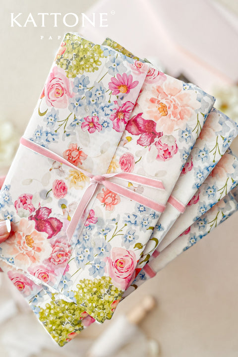 Announce your special day with a touch of modern romance with these exquisite wedding invitations. Perfect for a summer wedding, each suite features a delicate floral design printed on a translucent vellum jacket. Your personal custom monogram adds an elegant and personal touch, and the invitations are printed on luxurious handmade paper, creating a beautifully layered and bespoke stationery set.