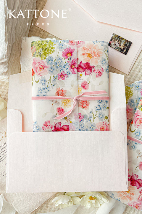 Announce your special day with a touch of modern romance with these exquisite wedding invitations. Perfect for a summer wedding, each suite features a delicate floral design printed on a translucent vellum jacket. Your personal custom monogram adds an elegant and personal touch, and the invitations are printed on luxurious handmade paper, creating a beautifully layered and bespoke stationery set.