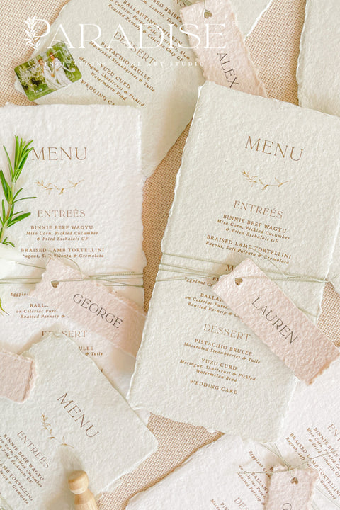 Add timeless charm and fine art elegance to your table styling with our handmade paper wedding menus, beautifully crafted from 100% cotton rag paper with naturally torn deckled edges. Each menu is adorned with a delicate name tag tied with fine thread, offering both practicality and sophistication as a combined menu and place card. The refined typography, minimal layout, and soft color palette bring a romantic yet modern touch, making these menus the perfect complement to luxury weddings, rehearsal dinners.