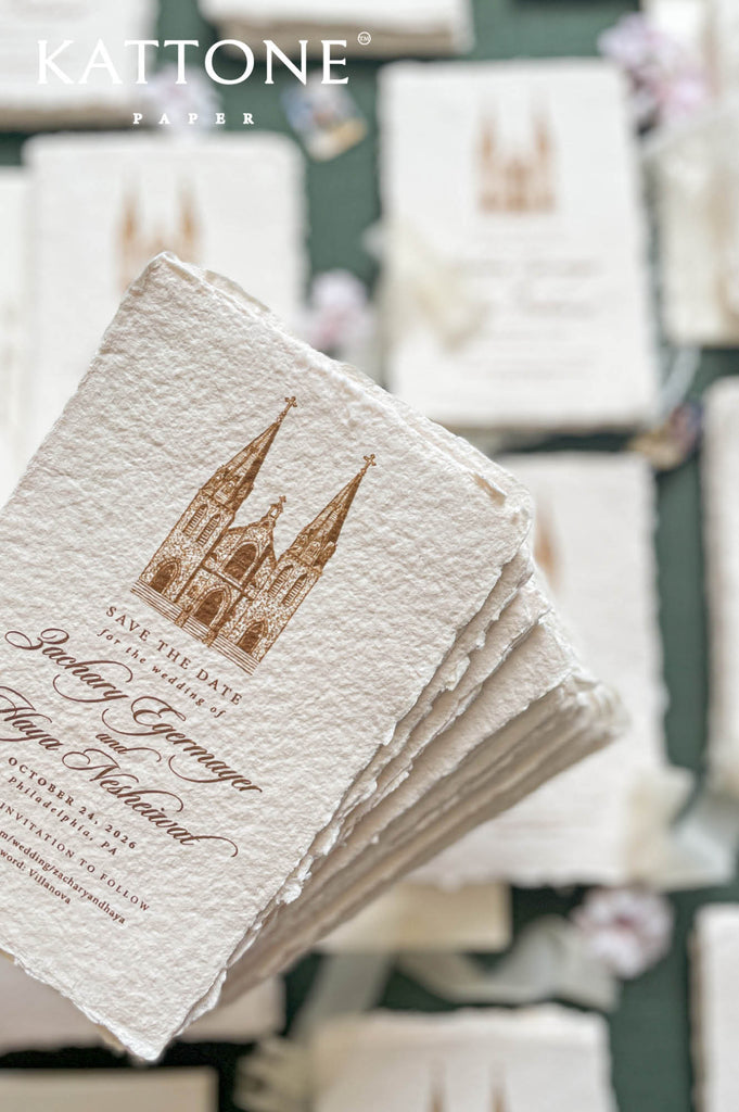 Close-up of handmade paper save the date card showing deckle edges and fine illustration detail.