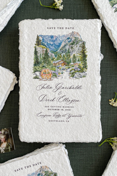 Handmade paper save the date cards with custom watercolor wedding venue illustration and deckle edges.