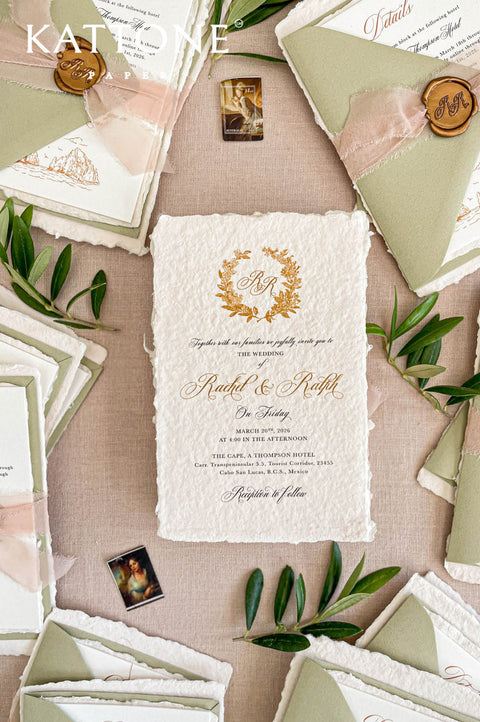 Luxury handmade paper wedding invitation with deckled edges and elegant gold typography on textured cotton paper