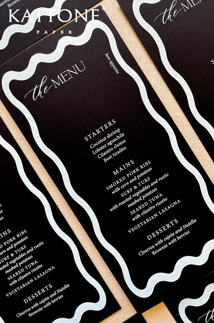 Black wedding menus with modern white typography and custom wax seal detail, styled for a rehearsal dinner or welcome event.