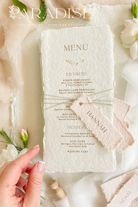 Add timeless charm and fine art elegance to your table styling with our handmade paper wedding menus, beautifully crafted from 100% cotton rag paper with naturally torn deckled edges. Each menu is adorned with a delicate name tag tied with fine thread, offering both practicality and sophistication as a combined menu and place card. The refined typography, minimal layout, and soft color palette bring a romantic yet modern touch, making these menus the perfect complement to luxury weddings, rehearsal dinners.