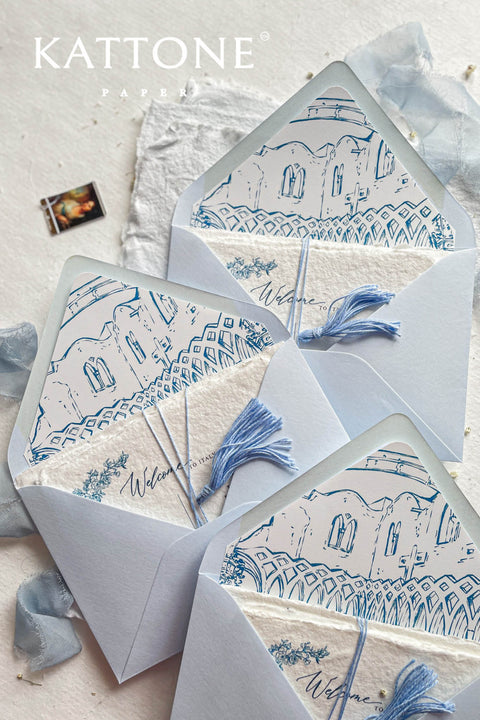 Close-up of hand-drawn venue illustration inside light blue envelope showing architectural line work and refined paper texture.