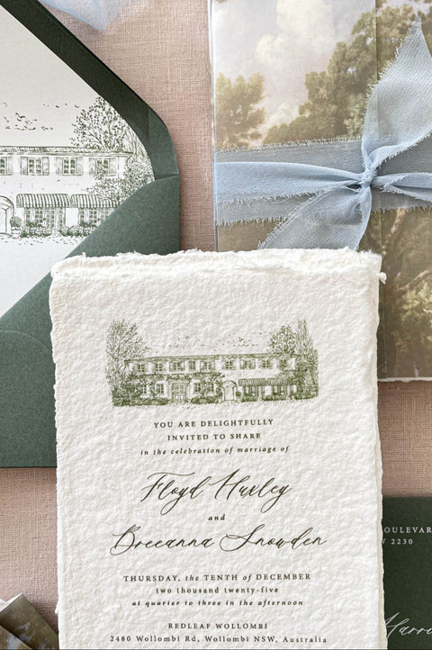 Luxury wedding stationery featuring a personalized venue illustration printed on handmade cotton paper, showcasing architectural details with soft green tones and fine line artwork.