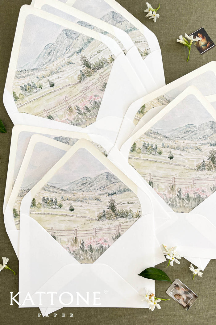 White wedding envelopes with custom watercolor landscape liner and fine art scenic illustration