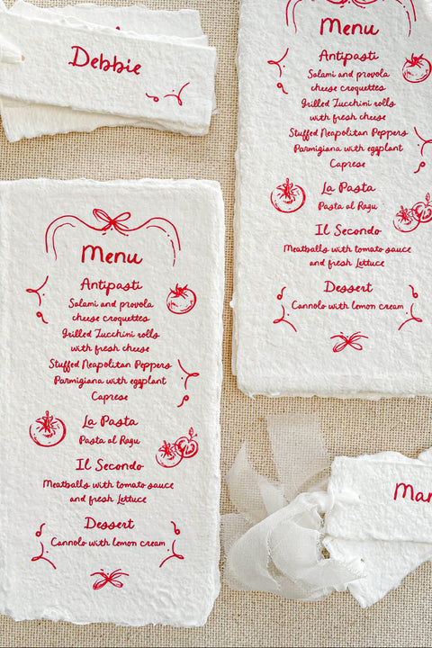 Bring playful charm to your table setting with our handmade paper place cards featuring whimsical red doodles. Each card is crafted from premium deckled-edge cotton paper and finished with delightful hand-drawn accents that add personality and joy to your celebration. Perfect for weddings, parties, kids’ events, or any occasion that calls for a touch of creativity.