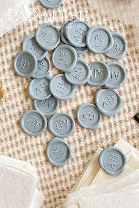 Soft, romantic, and timeless, these dusty blue wax seals add an elevated finishing touch to wedding invitations, envelopes, and fine-art stationery. Hand-poured and individually stamped, each seal features a smooth matte finish with subtle organic variation, making every piece beautifully unique. Perfect for classic, coastal, or modern wedding aesthetics, they pair effortlessly with handmade paper, vellum wraps, and silk ribbons.