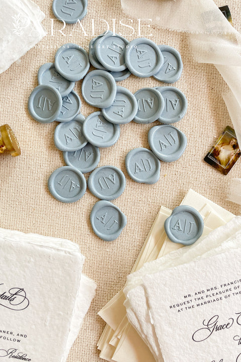 Soft, romantic, and timeless, these dusty blue wax seals add an elevated finishing touch to wedding invitations, envelopes, and fine-art stationery. Hand-poured and individually stamped, each seal features a smooth matte finish with subtle organic variation, making every piece beautifully unique. Perfect for classic, coastal, or modern wedding aesthetics, they pair effortlessly with handmade paper, vellum wraps, and silk ribbons.