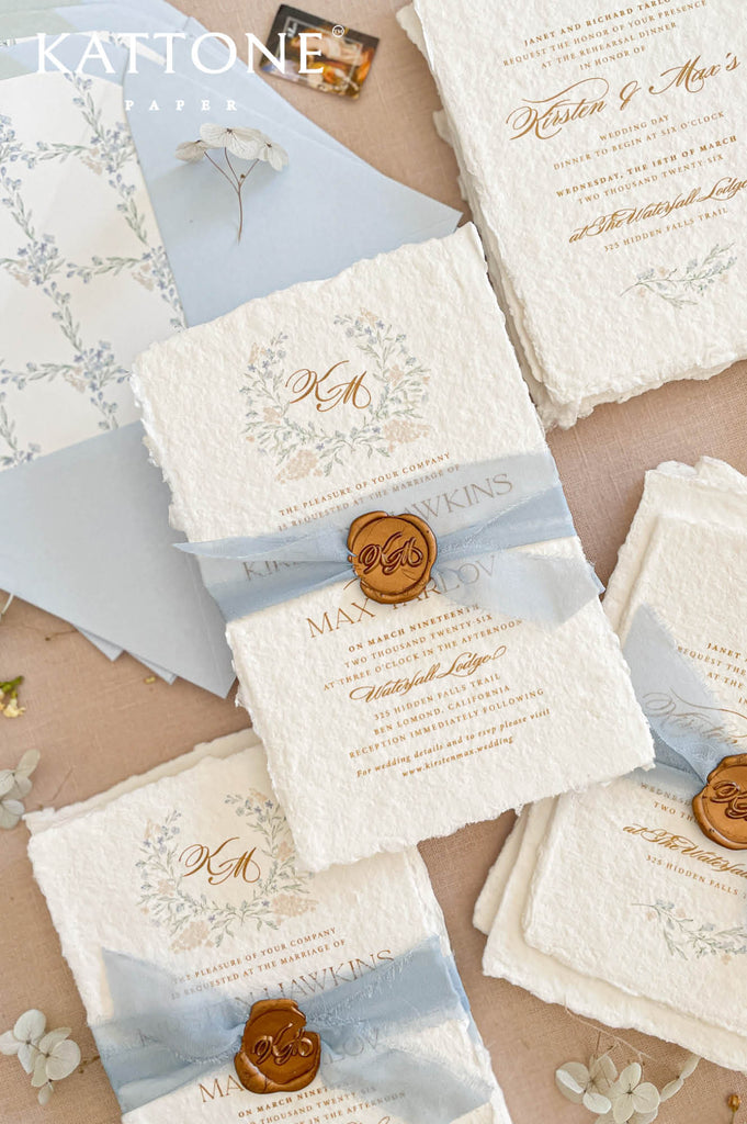 Complete luxury handmade wedding invitation suite including invitation card, details card, envelope liner, silk ribbon and wax seal with botanical design theme.