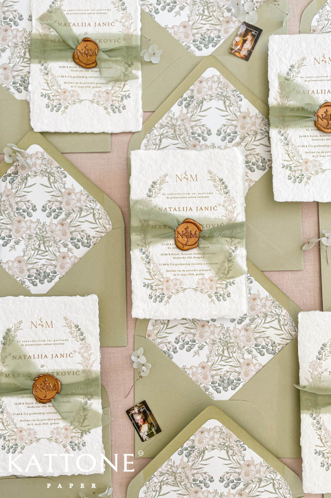 Fine art wedding invitation suite styled in a flat lay with handmade paper invitations, RSVP and details cards, envelopes and silk ribbon accents.