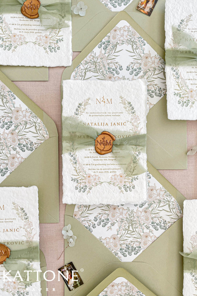 Fine art wedding invitation suite styled in a flat lay with handmade paper invitations, RSVP and details cards, envelopes and silk ribbon accents.