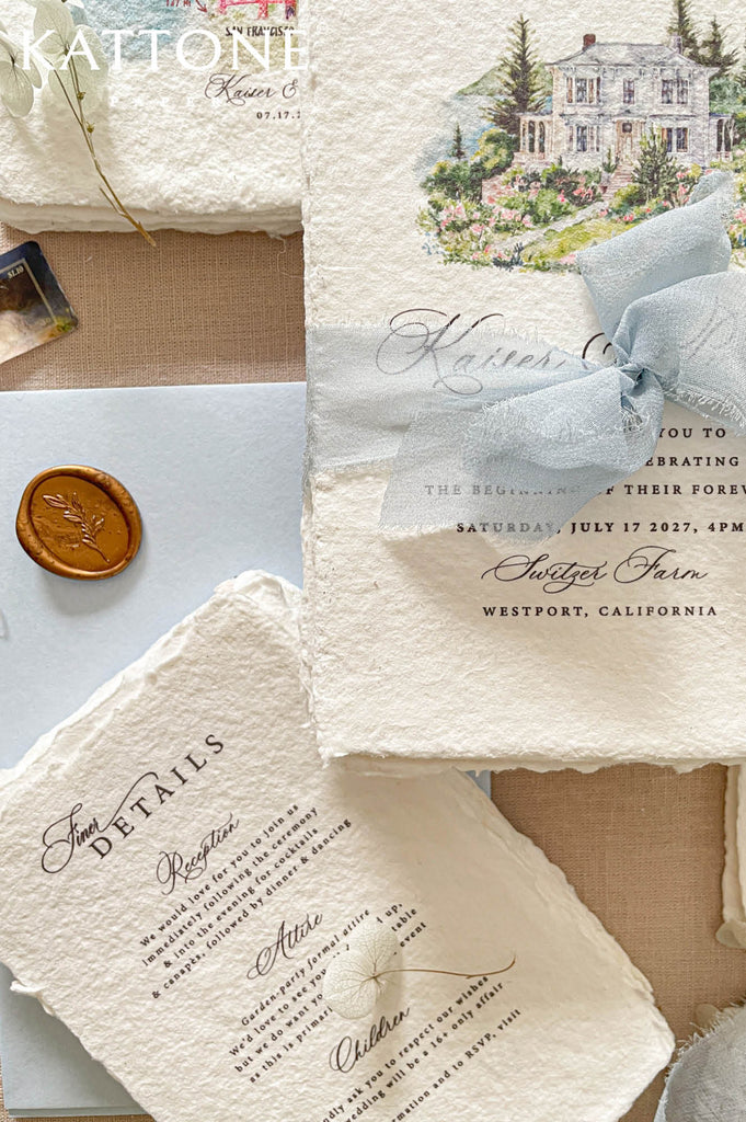 Elegant deckled edge handmade cotton paper wedding invitation featuring a custom watercolor house illustration, refined typography, and a soft dusty blue chiffon ribbon wrap.