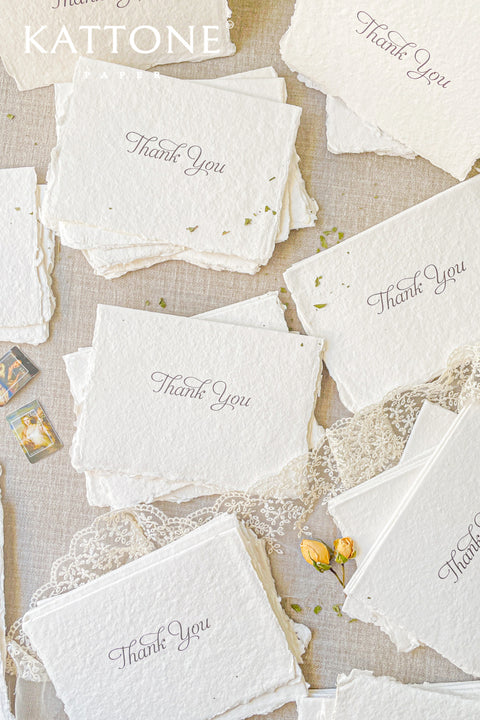 Express gratitude in its most timeless form with these handmade paper thank you cards. Crafted from thick, textured cotton paper with naturally deckled edges, each card feels organic, refined, and intentionally understated. Soft neutral tones and elegant calligraphy create a versatile design that pairs beautifully with weddings, baptisms, christenings, and fine-art celebrations. Designed to be written by hand and cherished long after the moment has passed.