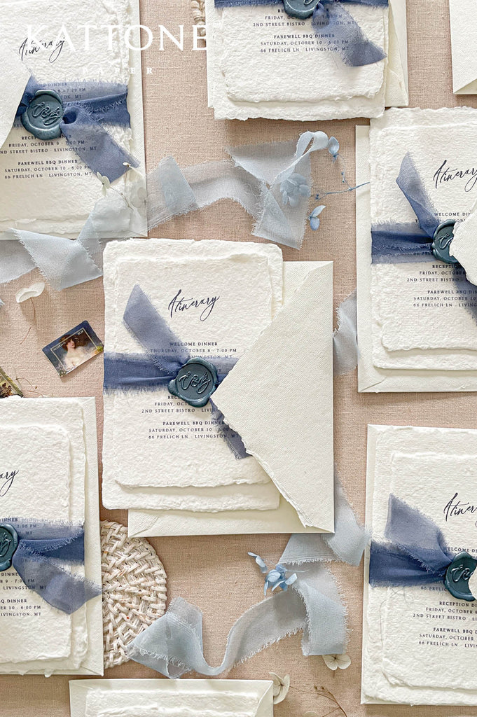 Deckled edge handmade paper itinerary card featuring elegant script typography and refined event schedule details for a multi-day wedding celebration.