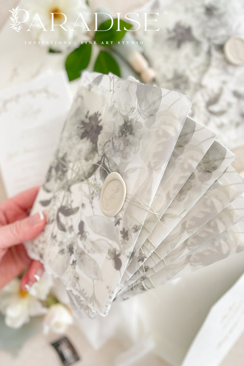 Our handmade wedding invitation suite features a custom hand-drawn monogram, printed on luxury deckled-edge cotton paper, and wrapped in translucent vellum jackets adorned with fine art floral illustrations. Each suite is finished with a silk ribbon and wax seal, blending old-world romance with modern artistry. Designed for couples who cherish attention to detail, this suite embodies elegance and craftsmanship - perfect for fine art, garden, or destination weddings.