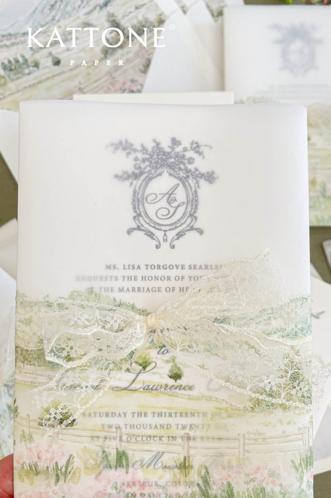 Close up of vellum wrap wedding invitation showing translucent overlay and watercolor scenery.