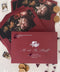 Burgundy wedding envelopes with printed guest addresses, crafted from premium paper and styled to showcase rich color, clean typography, and refined stationery quality.