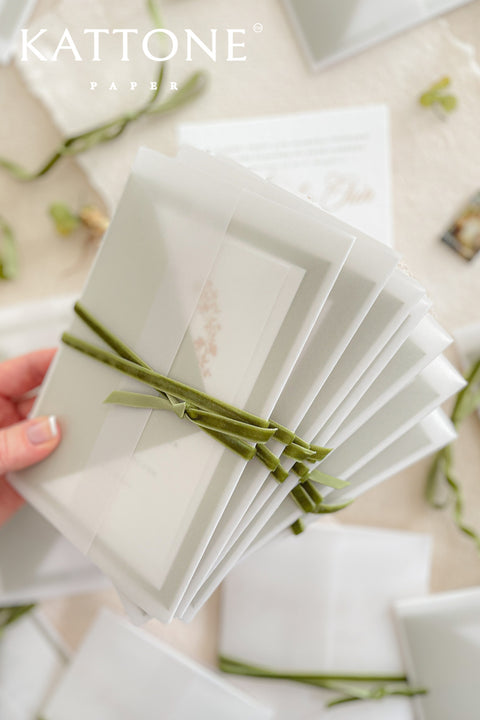 Elegant, timeless, and infused with personal charm - this wedding invitation suite was designed to announce your celebration with sophistication and warmth. Printed on luxury cotton paper. The suite features a beautifully hand-drawn monogram, symbolizing the union of two names in an artful botanical wreath. A romantic script font paired with refined serif text brings balance and grace, while vellum jackets and olive ribbons add layers of soft, organic beauty.