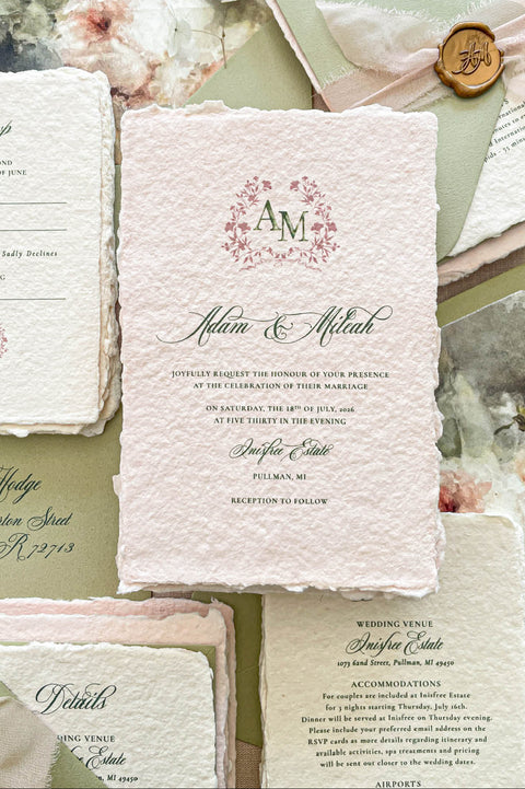 Luxury colored handmade paper wedding invitation suite featuring blush pink deckled edge cotton paper, floral monogram artwork, sage green typography, and watercolor floral liners for romantic wedding stationery.