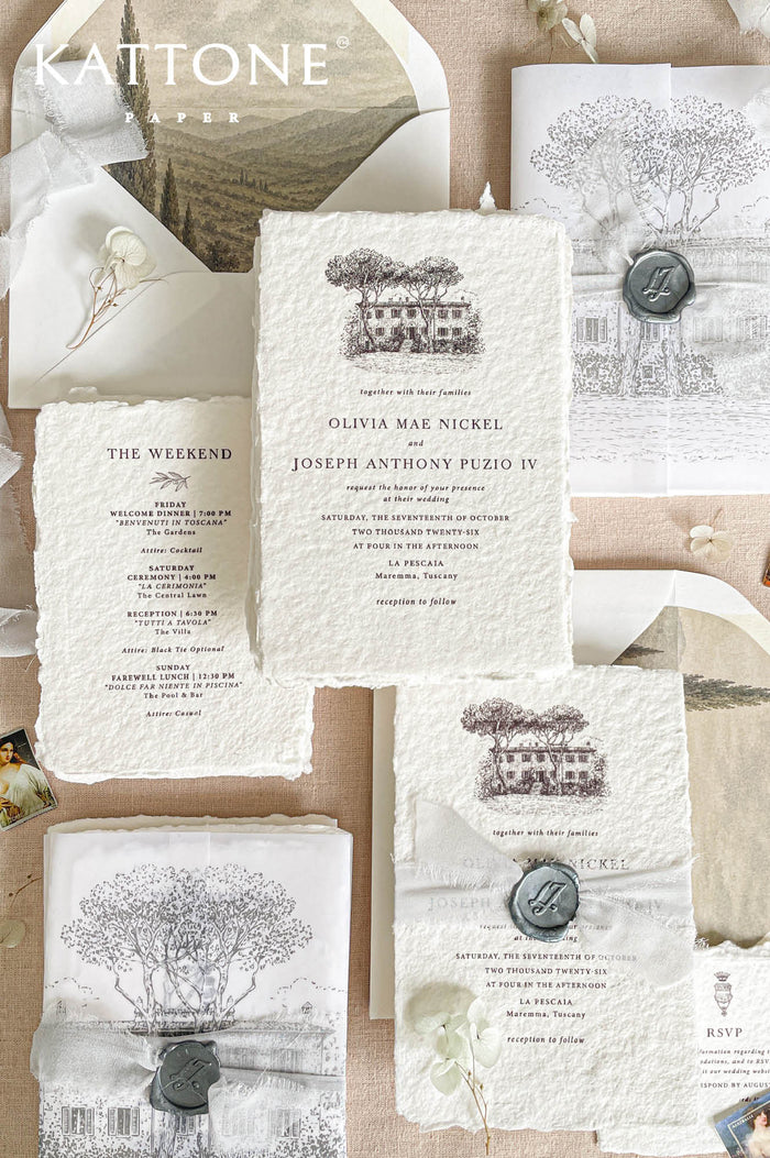 Luxury handmade paper wedding invitation suite featuring deckled edge cotton paper, custom architectural venue drawing, soft vellum wraps, personalized wax seals, weekend itinerary cards, and scenic neutral envelope liners.