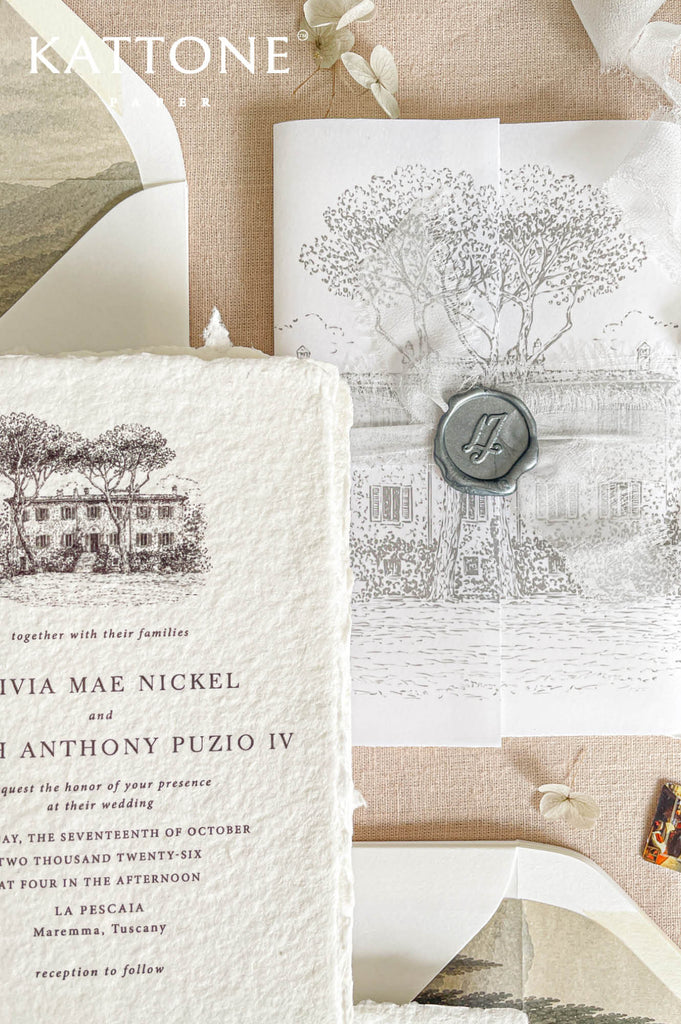 Soft translucent vellum wrap layered over handmade paper invitation with personalized wax seal for a romantic and elevated presentation.