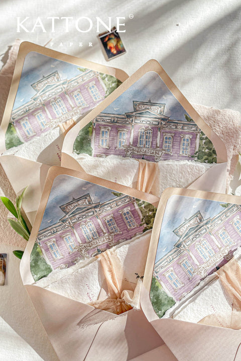 Overlapping envelopes revealing watercolor venue liners, emphasizing architectural illustration and elegant invitation presentation.