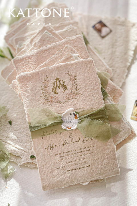Soft, organic, and undeniably romantic - this colored handmade paper wedding invitation suite beautifully captures the essence of nature-inspired elegance. Printed on luxury blush-toned deckled-edge cotton paper, each piece is a work of art, blending timeless craftsmanship with delicate botanical elements and refined greenery details. At its heart lies a custom hand-drawn monogram, surrounded by soft watercolor foliage - a symbol of the couple’s unity and natural grace. 