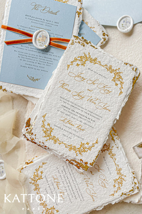 Invite your guests to your special day with the artful beauty of these exquisite handmade paper wedding invites. Perfect for a garden wedding, these invitations feature a delicate golden leaf addition, providing a touch of understated elegance and luxurious shimmer. The tactile and organic feel of the deckle edge paper creates a truly memorable keepsake, setting a romantic and refined tone for your celebration.