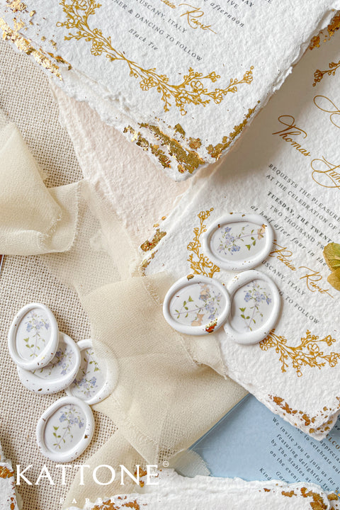 Add a delicate, nature-inspired finish to your stationery with these handcrafted botanical wax seals. Featuring a soft ivory base with pressed floral detailing, each seal brings an organic, romantic touch that feels timeless and elevated. Perfect for fine art wedding invitations, vow books, envelopes, and keepsake packaging, these wax seals pair beautifully with handmade paper, silk ribbon, and gold-accented designs.