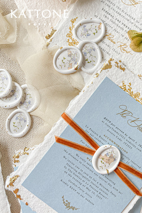 Add a delicate, nature-inspired finish to your stationery with these handcrafted botanical wax seals. Featuring a soft ivory base with pressed floral detailing, each seal brings an organic, romantic touch that feels timeless and elevated. Perfect for fine art wedding invitations, vow books, envelopes, and keepsake packaging, these wax seals pair beautifully with handmade paper, silk ribbon, and gold-accented designs.
