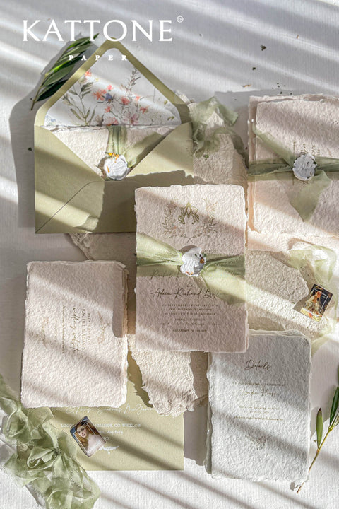 Soft, organic, and undeniably romantic - this colored handmade paper wedding invitation suite beautifully captures the essence of nature-inspired elegance. Printed on luxury blush-toned deckled-edge cotton paper, each piece is a work of art, blending timeless craftsmanship with delicate botanical elements and refined greenery details. At its heart lies a custom hand-drawn monogram, surrounded by soft watercolor foliage - a symbol of the couple’s unity and natural grace. 