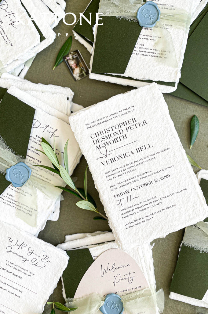 Handmade paper RSVP card with clean modern layout and deckle edge texture for an elegant wedding stationery suite.