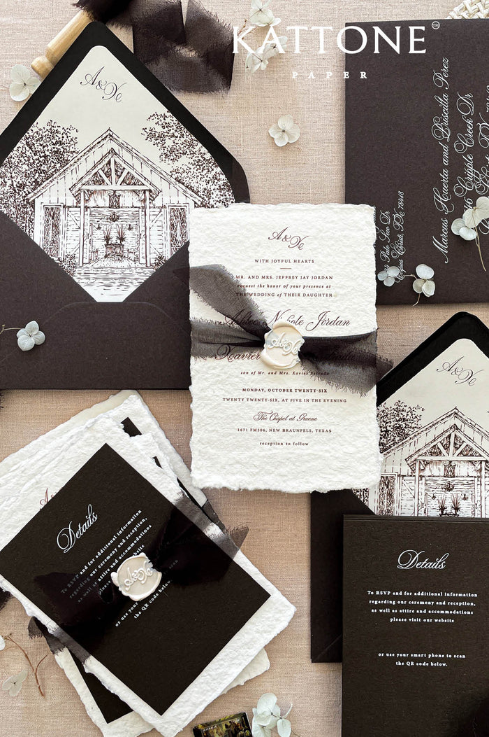 Luxury handmade paper wedding invitation suite with deep espresso envelopes, chapel illustration liners, black ribbon, and wax seal.
