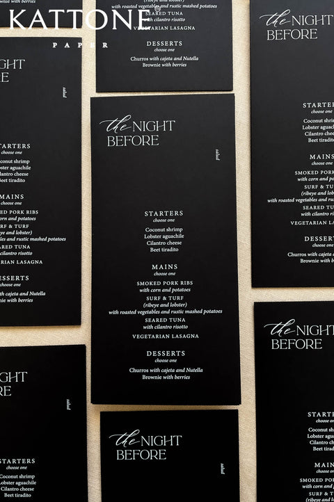 Rehearsal dinner table stationery featuring black wedding menus and modern minimalist design.