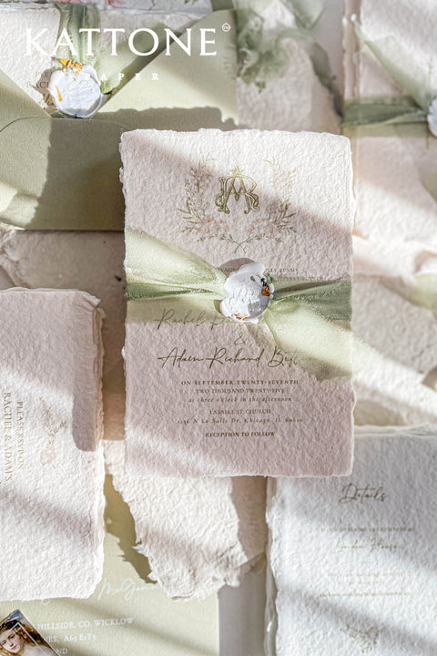 Soft, organic, and undeniably romantic - this colored handmade paper wedding invitation suite beautifully captures the essence of nature-inspired elegance. Printed on luxury blush-toned deckled-edge cotton paper, each piece is a work of art, blending timeless craftsmanship with delicate botanical elements and refined greenery details. At its heart lies a custom hand-drawn monogram, surrounded by soft watercolor foliage - a symbol of the couple’s unity and natural grace. 