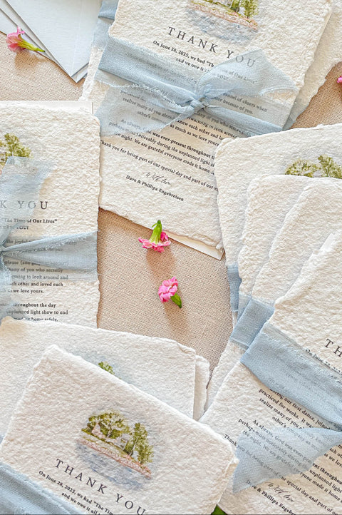 Fine art wedding thank you cards with watercolor venue illustration styled with flowers and ribbon.